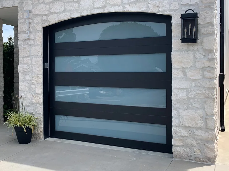 Contemporary black aluminum frame glass garage door installation in Corona Del Mar, Orange County CA
