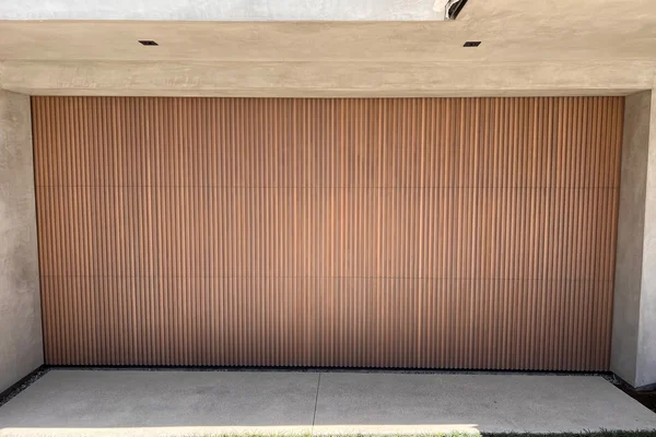Cedar stain grade custom wood garage door installation in Newport Beach, CA -- Avaunt Garage Doors