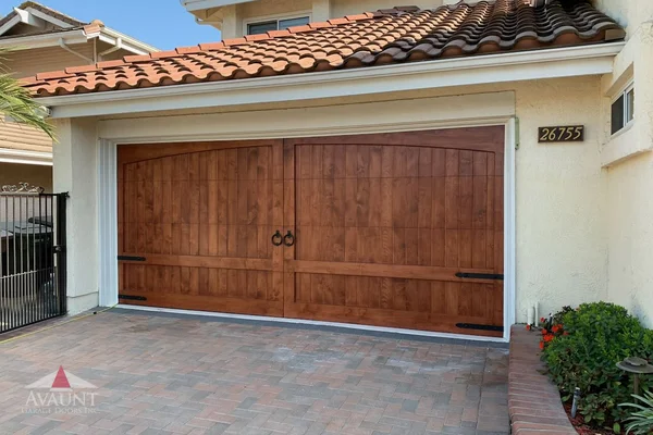 Clear Alder stain grade custom wood garage door installation in Laguna Hills, CA -- Avaunt Garage Doors