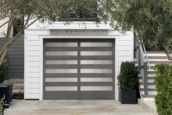 Clear Alder stain grade custom wood garage door installation in Laguna Beach, CA -- Avaunt Garage Doors