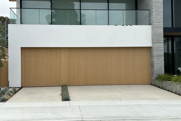 Alaskan Yellow Cedar stain grade custom wood garage door installation in Newport Beach, CA -- Avaunt Garage Doors